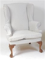 Lot 1629 - A walnut framed wing armchair, in the early...