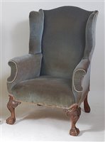 Lot 1630 - A walnut framed wing armchair in the early...