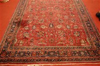 Lot 1565 - A Persian woollen puce ground carpet,...