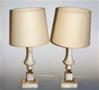 Lot 14 - A pair of onyx and brass mounted table lamps...