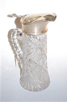 Lot 258 - A cut glass claret jug, having silver collar...