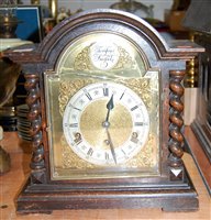 Lot 173 - A 1920s oak cased mantel clock having an...