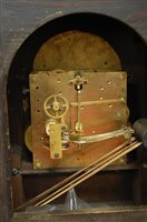 Lot 173 - A 1920s oak cased mantel clock having an...