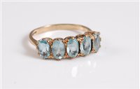 Lot 335 - A 9ct five stone topaz ring, the five oval...