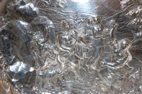Lot 277 - A silver oval dish, the ground worked in...