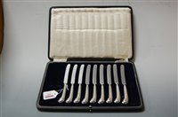 Lot 295 - A cased set of nine butter knives, each having...