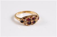 Lot 339 - A garnet and seed pearl ring, the four round...