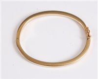 Lot 365 - A 9kt gold hinged bangle, the plain 4mm wide...