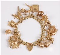 Lot 370 - A curblink style charm bracelet with heart...