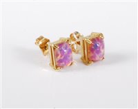 Lot 448 - A pair of faux opal earrings, the oval...