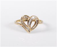 Lot 447 - A '10k' diamond heart shaped ring, the...