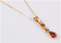 Lot 2581 - An 18ct ruby and diamond pendant, the pear...