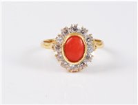 Lot 2573 - An 18ct coral and CZ ring, the oval coral...