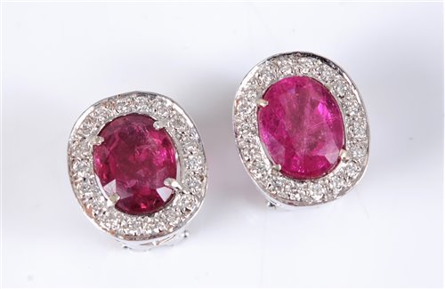 Lot 1231 - A pair of pink sapphire and diamond cluster...