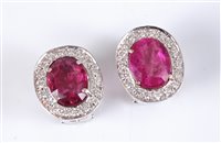 Lot 1231 - A pair of pink sapphire and diamond cluster...