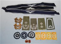 Lot 304 - A collection of German cap badges and cloth...