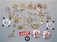 Lot 310 - A collection of assorted cap badges and...