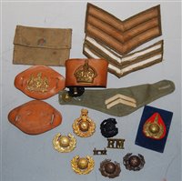 Lot 311 - A small collection of assorted cap badges,...