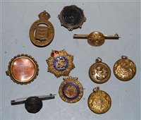 Lot 317 - A small collection of assorted cap badges and...