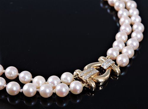Lot 1263 - A two strand cultured pearl necklace with 18ct...