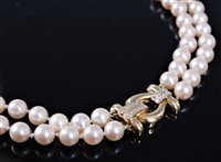 Lot 1263 - A two strand cultured pearl necklace with 18ct...