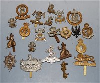 Lot 364 - A collection of 22 assorted cap badges and...