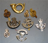 Lot 395 - A small collection of cap badges and insignia,...