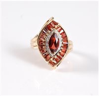 Lot 2575 - A 14k ruby and diamond cluster ring, the...