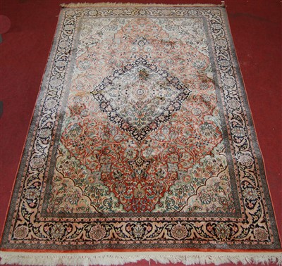 Lot 1560 - A Persian woven silk Tabriz rug, the red...