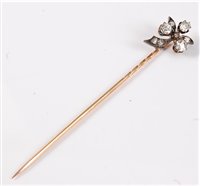 Lot 2501 - A diamond stick pin: the three round old cut...