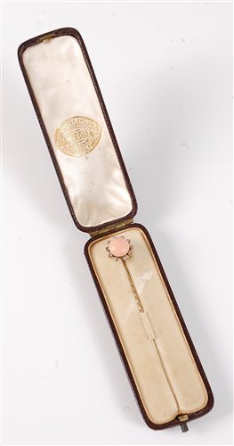 Lot 2504 - A coral and diamond stick pin: the round coral...