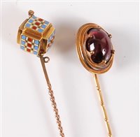 Lot 2505 - Two stick pins: the first set with a garnet...