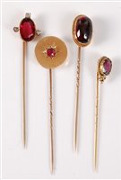 Lot 2506 - Four gemset stick pins: to include an oval...