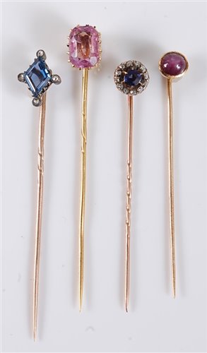 Lot 2509 - Four gemset stick pins: to include a pink...
