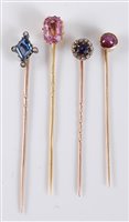 Lot 2509 - Four gemset stick pins: to include a pink...