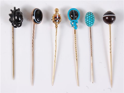 Lot 2514 - Six gemset stick pins: a banded agate and blue...