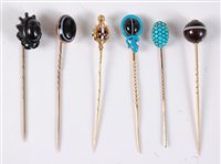 Lot 2514 - Six gemset stick pins: a banded agate and blue...