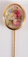 Lot 2516 - A painted ivory stick pin: the oval ivory...