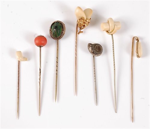 Lot 2518 - Seven stick pins: a stags tooth stick pin, the...
