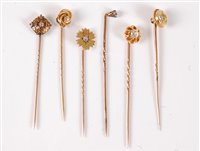 Lot 2521 - Six diamond set stick pins: an old cut diamond...
