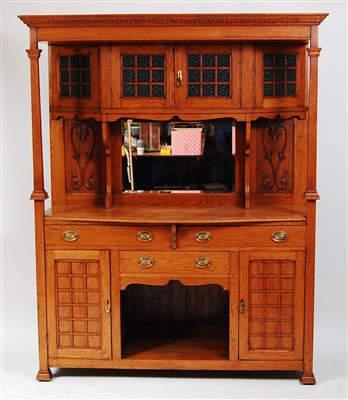 Lot 421 - An Arts & Crafts oak mirrorback sideboard, the...