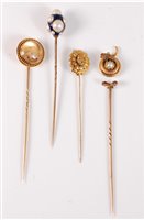 Lot 2526 - Four stick pins: to include a reverse painted...