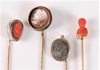 Lot 2530 - Four cameo stick pins: a round painted...