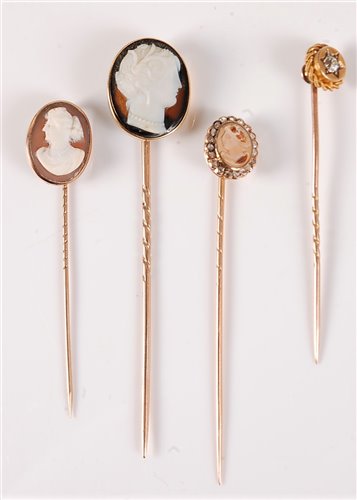 Lot 2531 - Three cameo stick pins and a diamond stick pin:...