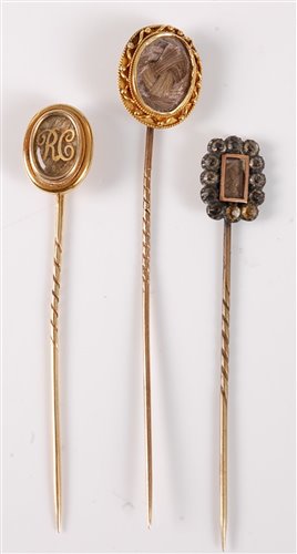 Lot 2533 - Three hairwork stick pins: an oval plaited...
