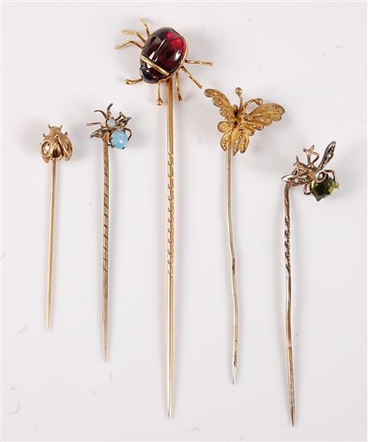 Lot 2537 - Five insect stick pins: a garnet spider stick...