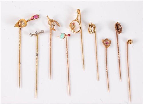 Lot 2538 - Nine variously gemset stick pins: a ruby and...