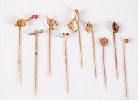 Lot 2538 - Nine variously gemset stick pins: a ruby and...