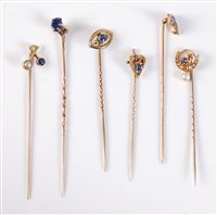 Lot 2542 - Six sapphire and seed pearl stick pins: a 15ct...