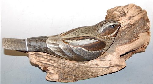 Lot 21 - A carved and painted model of a bird mounted...